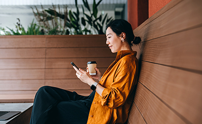 A woman on a bench texting